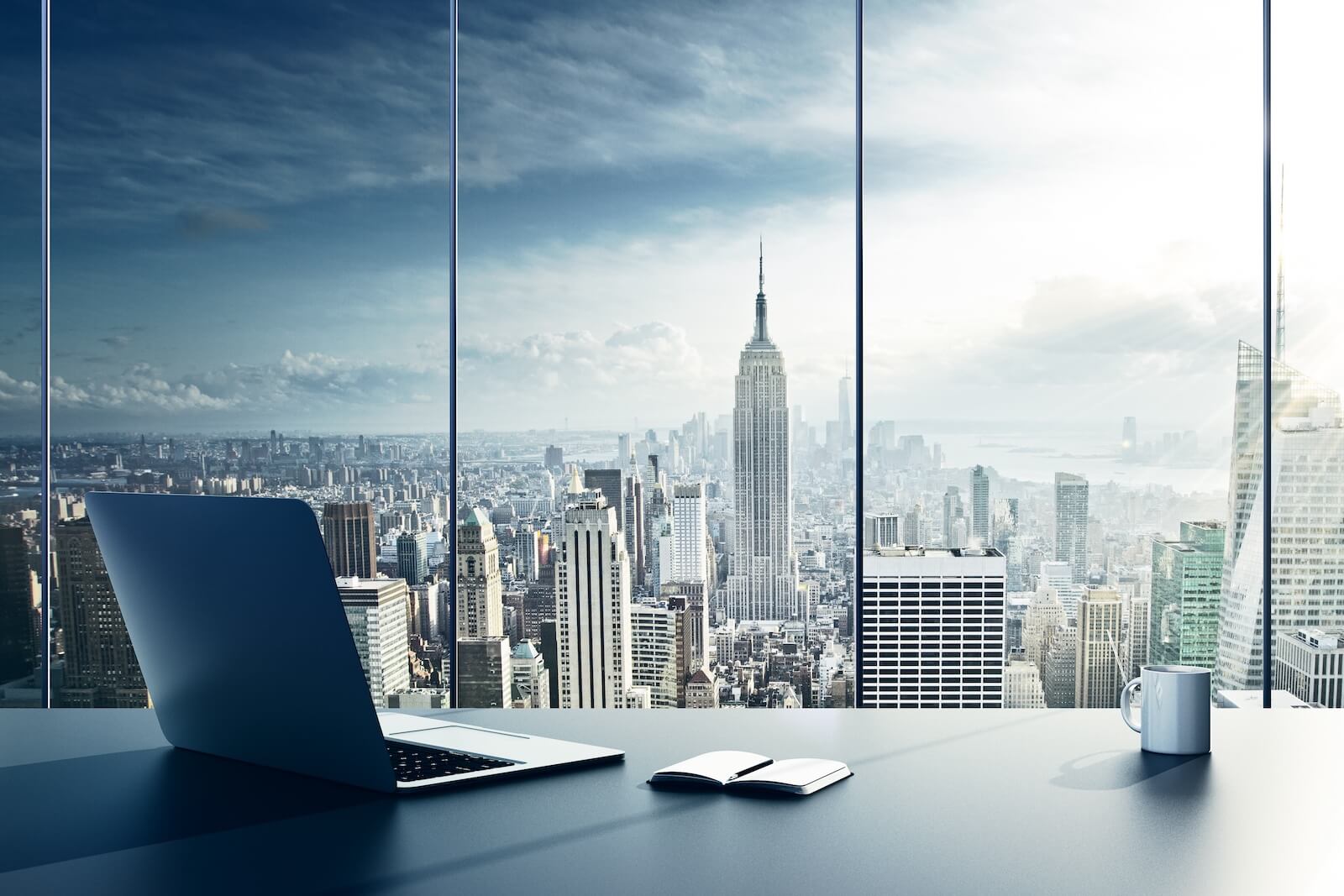 View of laptop and a desk overlooking NYC